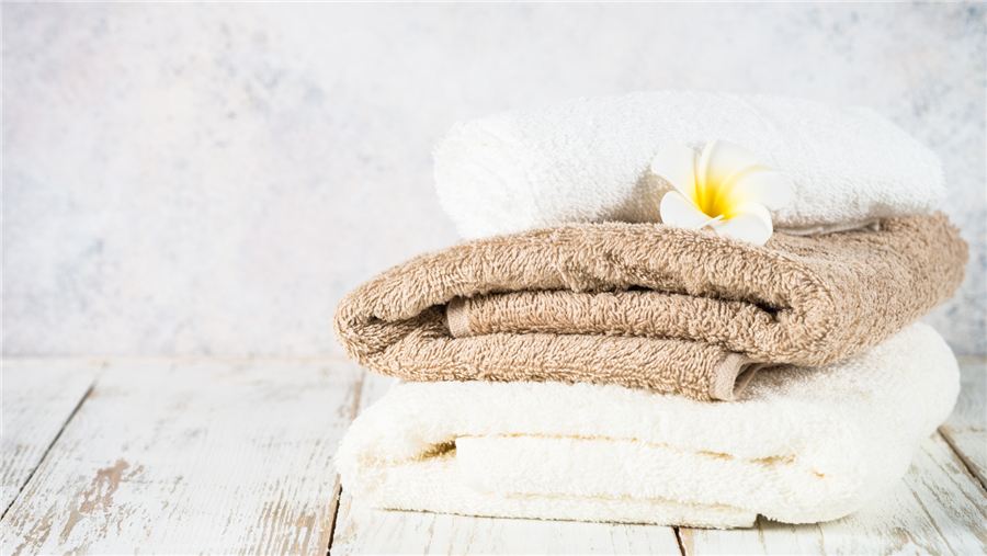 Premium hotel room details showcasing linens, bathrobes and slippers